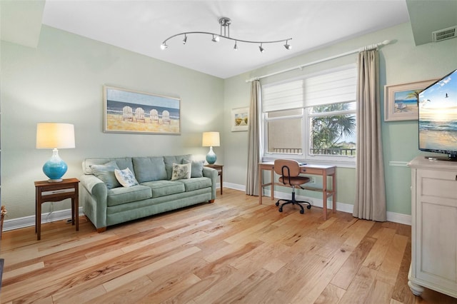 office space featuring light wood-type flooring and built in desk