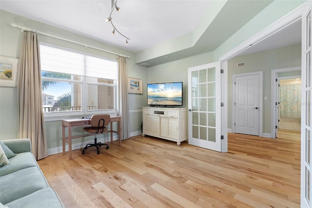 office with light wood-type flooring