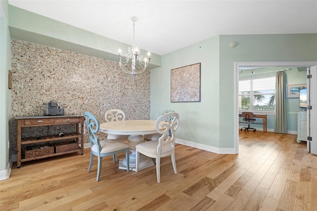 dining room featuring a notable chandelier and light hardwood / wood-style floors