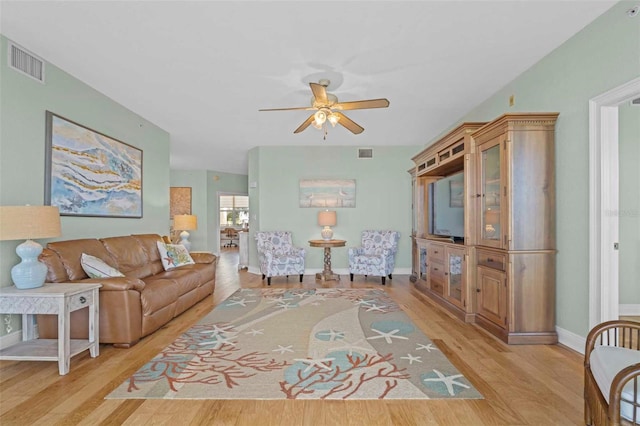 living room featuring light hardwood / wood-style floors and ceiling fan