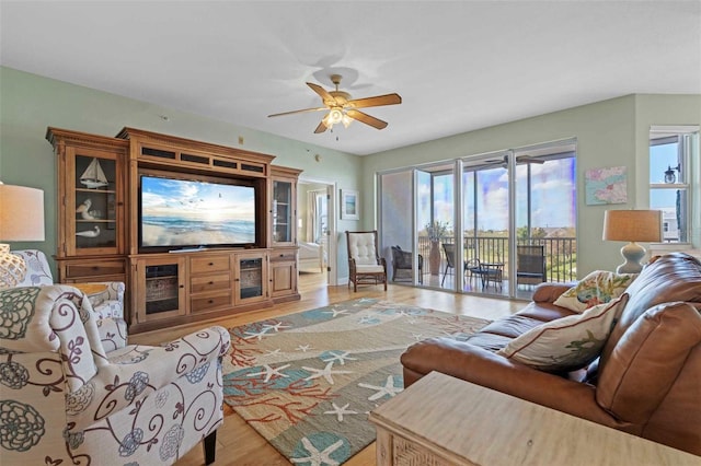 living room featuring light hardwood / wood-style flooring and ceiling fan