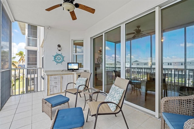 sunroom featuring ceiling fan