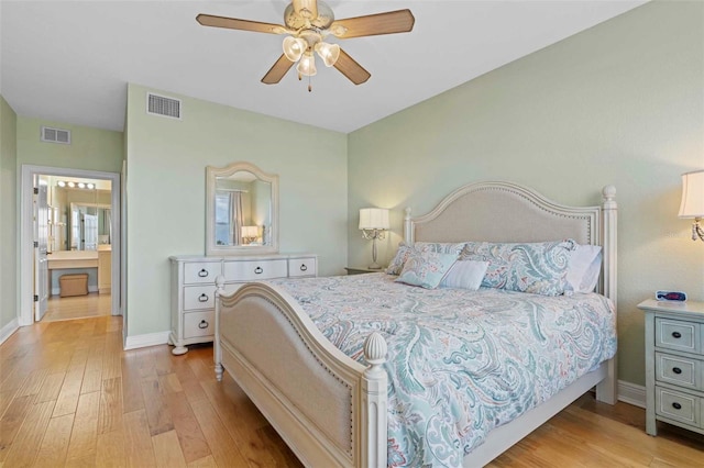 bedroom featuring ceiling fan, ensuite bath, and light hardwood / wood-style flooring