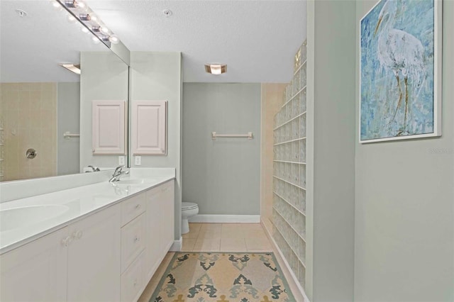 268 Lewis Cir Unit 132, Punta Gorda, FL 33950 - bathroom featuring double vanity, a walk in shower, tile patterned floors, and a textured ceiling