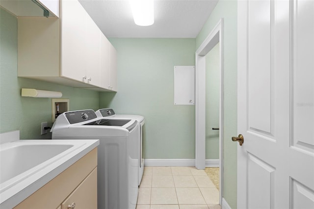 washroom featuring a textured ceiling, cabinets, independent washer and dryer, and light tile patterned flooring