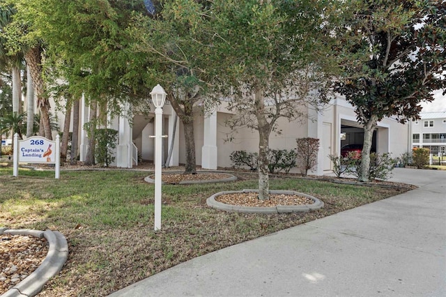 268 Lewis Cir Unit 132, Punta Gorda, FL 33950 - view of front facade with stucco siding, driveway, a front yard, and a garage
