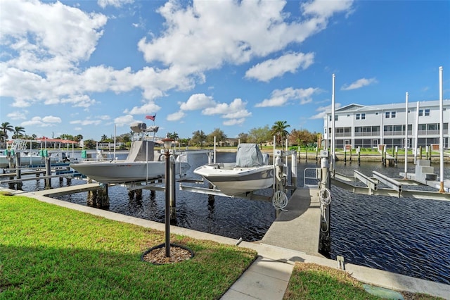 dock area with a water view and a lawn