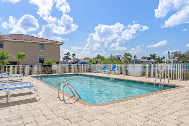 view of swimming pool featuring a patio area