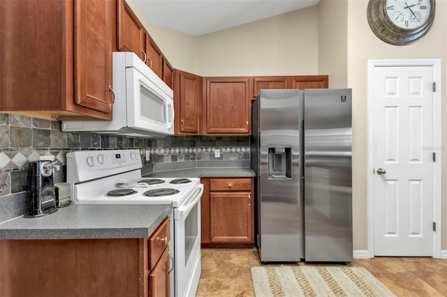 kitchen with tasteful backsplash, white appliances, vaulted ceiling, and light tile patterned floors