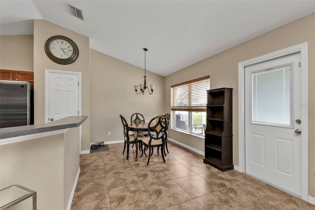 dining room featuring lofted ceiling and a chandelier