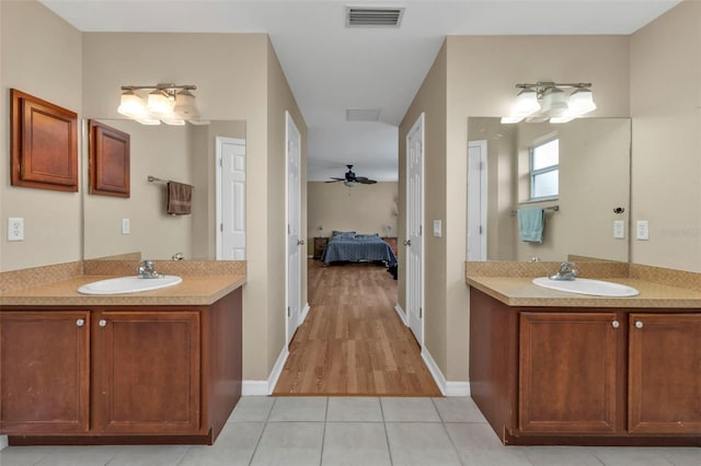 bathroom featuring wood-type flooring, ceiling fan, and vanity