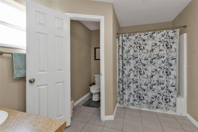 full bathroom with vanity, shower / tub combo with curtain, tile patterned floors, and toilet