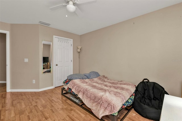 bedroom with light wood-type flooring and ceiling fan