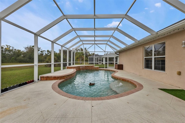 view of swimming pool featuring a lawn, glass enclosure, and a patio