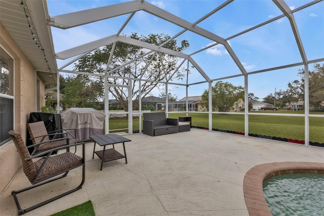 view of patio / terrace with grilling area and glass enclosure