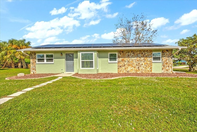 single story home with a front lawn and solar panels