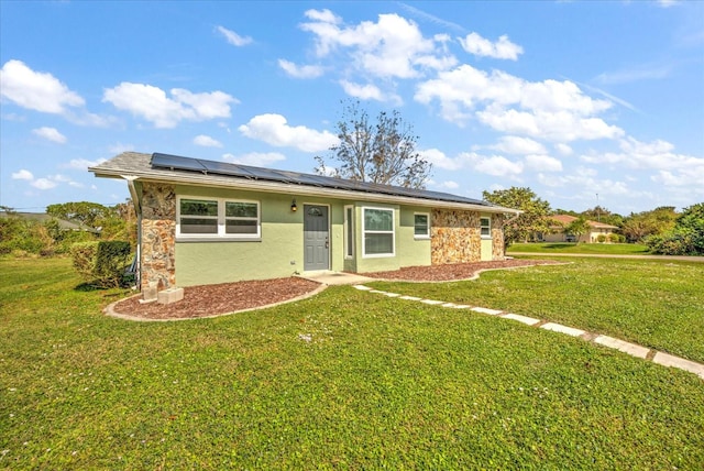 single story home with solar panels and a front yard