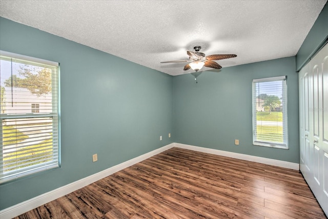 spare room with wood-type flooring, a textured ceiling, and ceiling fan