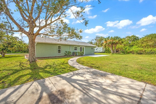 back of property with a lawn