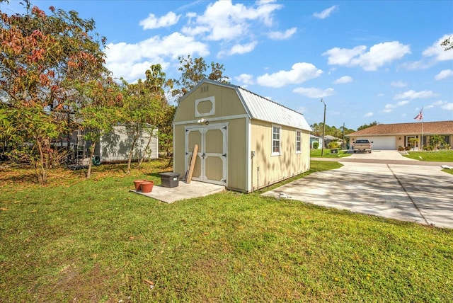 view of outbuilding featuring a yard