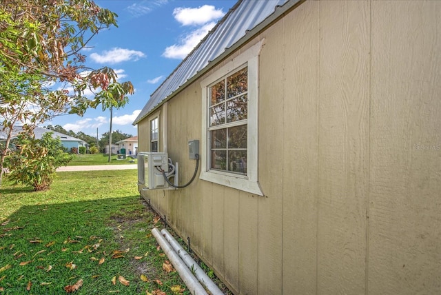 view of side of property with a lawn