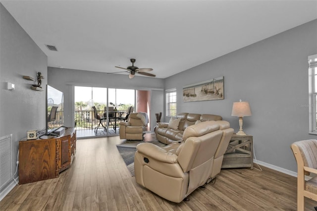 living room with ceiling fan and light wood-type flooring