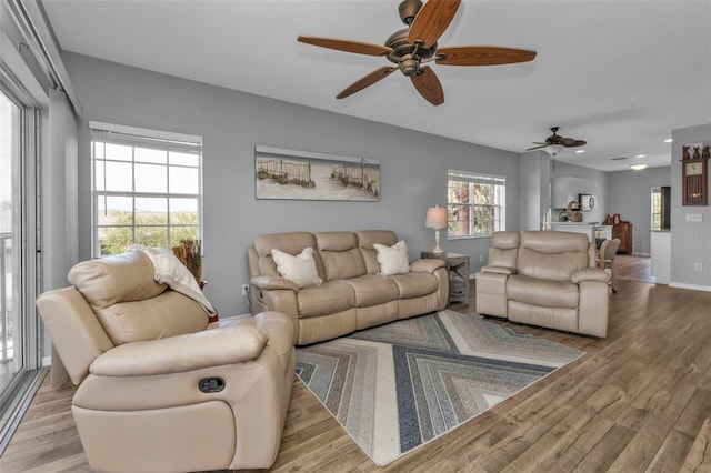 living room featuring light hardwood / wood-style floors and ceiling fan