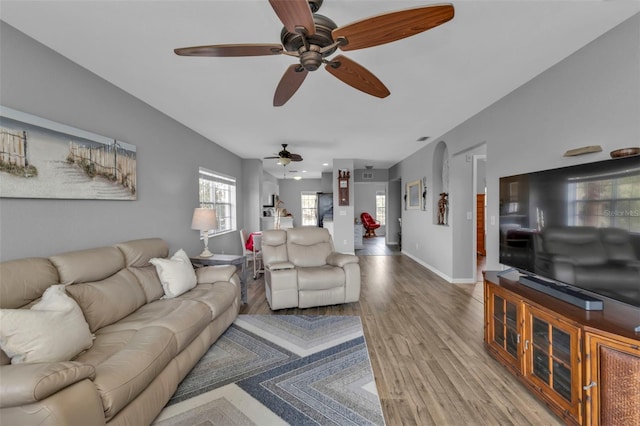 living room featuring hardwood / wood-style flooring and ceiling fan