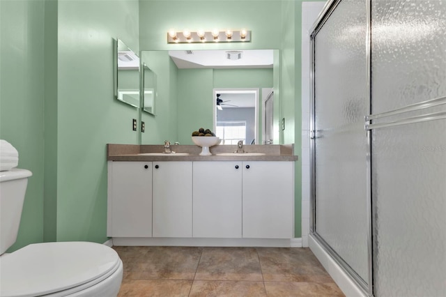 bathroom featuring tile patterned floors, toilet, an enclosed shower, vanity, and ceiling fan