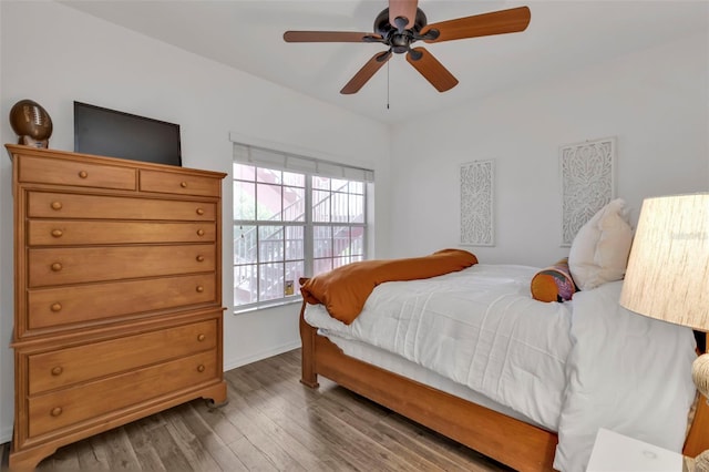 bedroom with hardwood / wood-style floors and ceiling fan