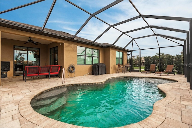 view of pool featuring glass enclosure, a patio area, area for grilling, and ceiling fan