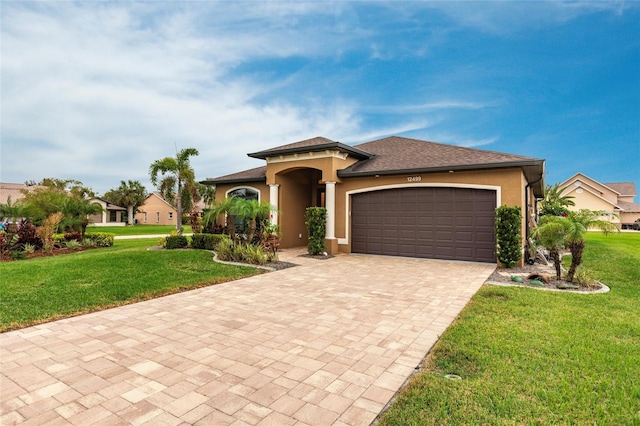 view of front of property with a front yard and a garage