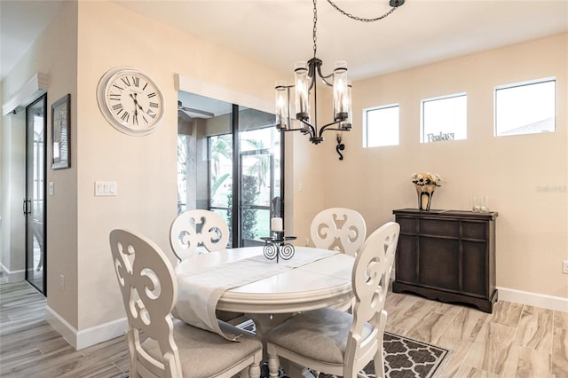 dining room featuring a wealth of natural light, a chandelier, and light hardwood / wood-style floors