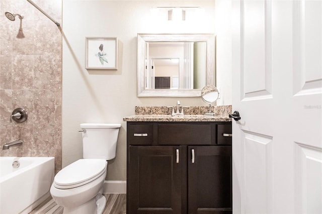 full bathroom featuring hardwood / wood-style flooring, vanity, toilet, and tiled shower / bath combo