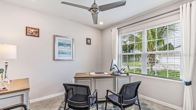 carpeted office space with ceiling fan