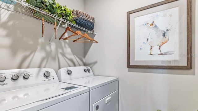 washroom with washing machine and clothes dryer