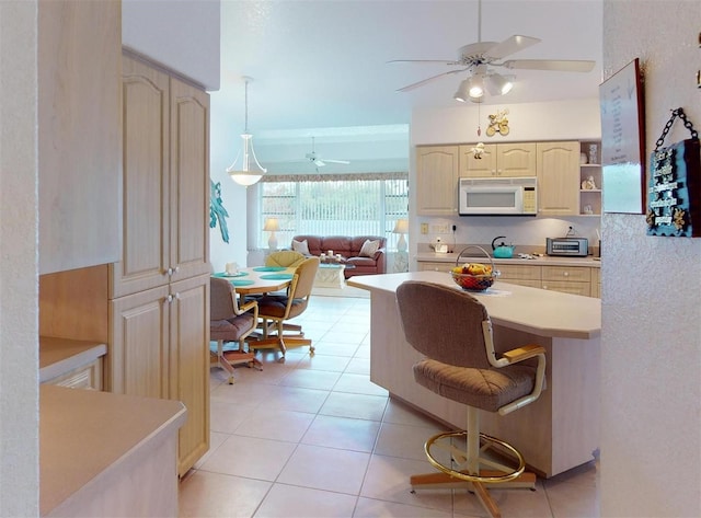 198 Coblentz St, Port Charlotte, FL 33954 - kitchen with white microwave, ceiling fan, light countertops, light tile patterned floors, and open shelves
