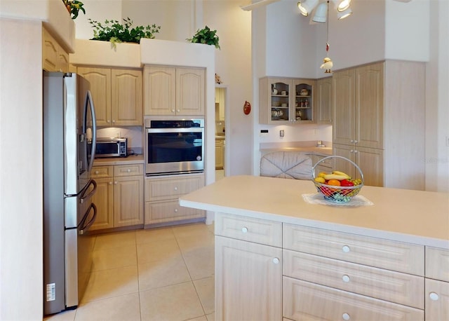 198 Coblentz St, Port Charlotte, FL 33954 - kitchen with appliances with stainless steel finishes, light brown cabinetry, light tile patterned flooring, glass insert cabinets, and light countertops
