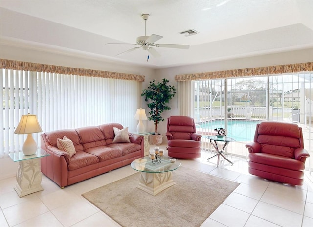 tiled living room with ceiling fan