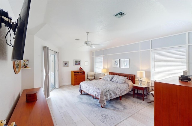 bedroom with multiple windows, ceiling fan, and light hardwood / wood-style floors