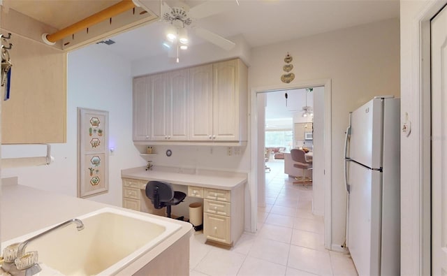 kitchen with ceiling fan, white fridge, light tile patterned flooring, and sink