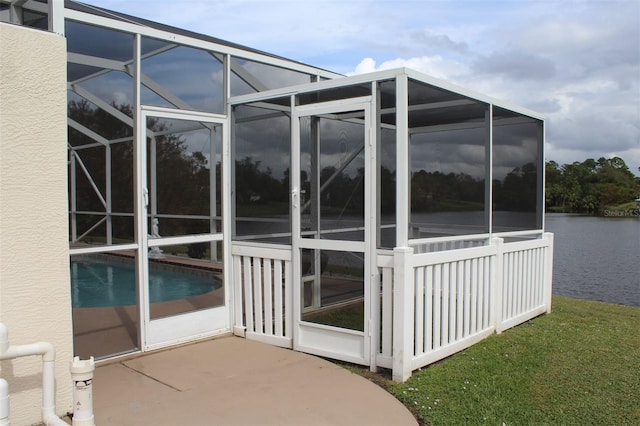 view of property exterior featuring a lanai and a water view