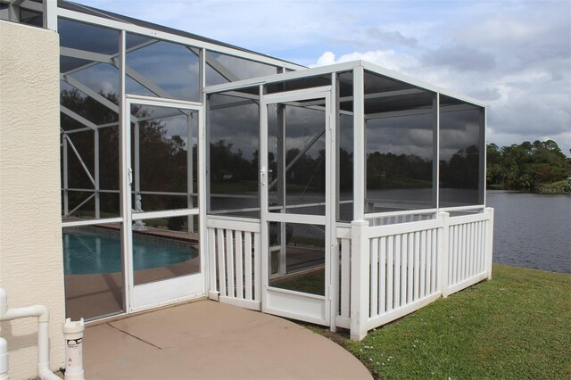 198 Coblentz St, Port Charlotte, FL 33954 - view of side of property with glass enclosure, stucco siding, and a water view