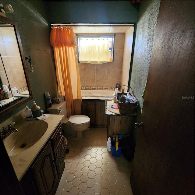 full bathroom with vanity, tile patterned floors, toilet, and tiled shower / bath