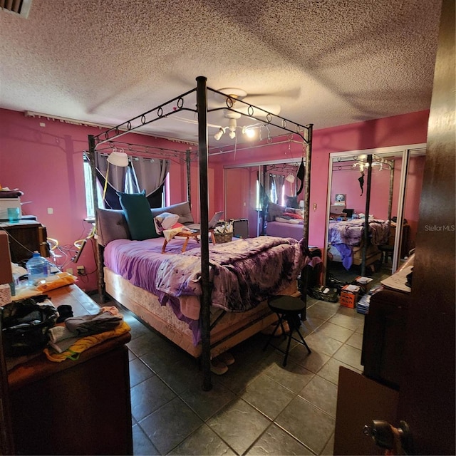 bedroom featuring a textured ceiling and tile patterned floors