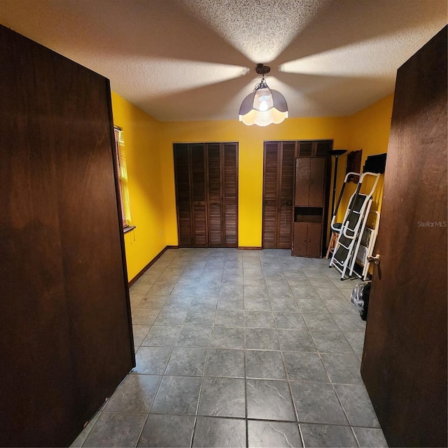 interior space featuring ceiling fan and a textured ceiling