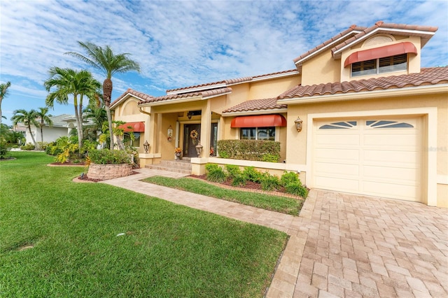 mediterranean / spanish-style house featuring a front lawn