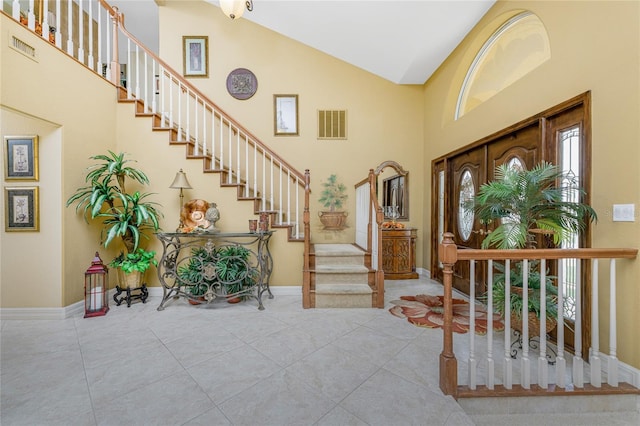 tiled entryway with high vaulted ceiling