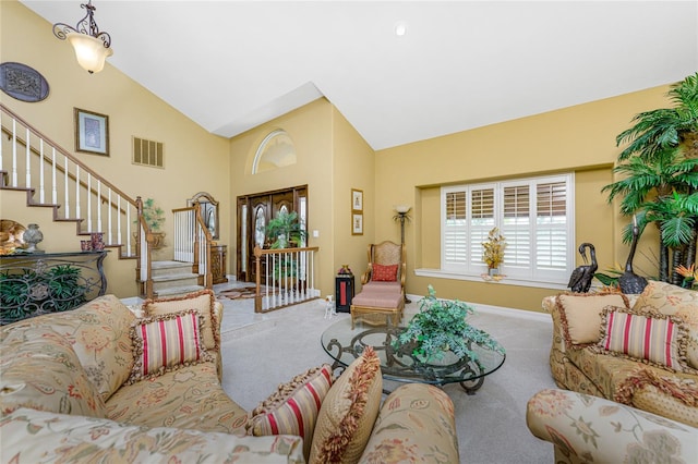 carpeted living room featuring high vaulted ceiling