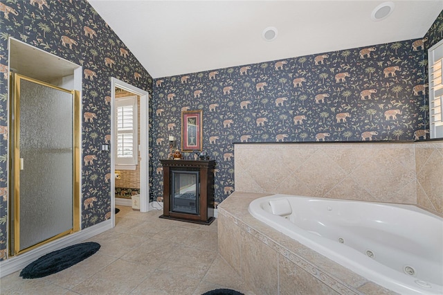 bathroom with tile patterned floors, separate shower and tub, and vaulted ceiling